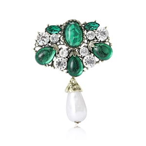 Vintage Baroque emerald brooch with crystals and teardrop pearl on white background