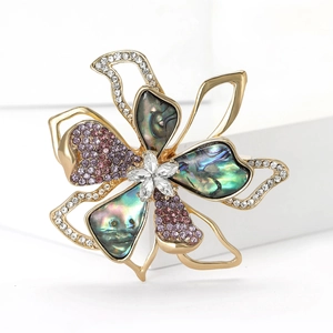 Elegant gold flower brooch with colorful abalone shell petals and sparkling crystals