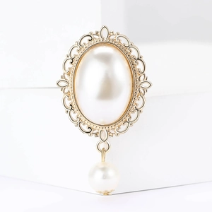 Detail der Barockperlenbrosche mit goldener Gravur und hängender Perle im Vintage-Stil