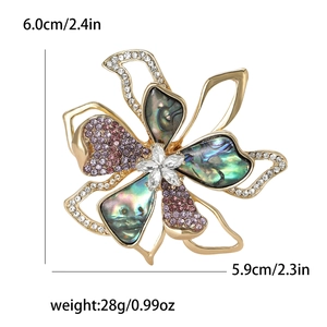 Vintage gold-plated floral brooch with abalone shell petals and crystal accents