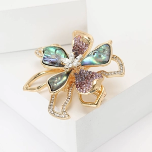 Exquisite vintage flower brooch with abalone shell and purple crystals on white stone