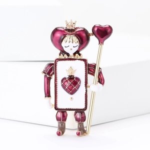 Detail of red enamel poker heart soldier brooch with gold finish and vintage texture