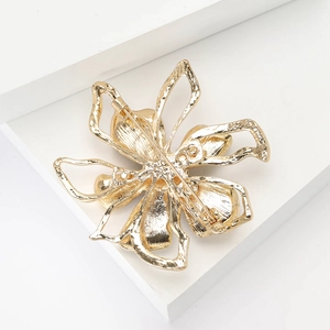 Vintage gold alloy flower brooch with shell and rhinestone, back view with secure pin