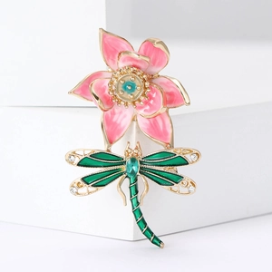 Macro shot of an elegant dragonfly lotus brooch with enamel finish and crystal accents