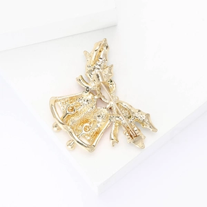 Detailed back view of Christmas bell brooch showing alloy texture and pin clasp mechanism