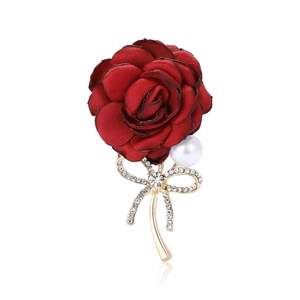 Elegant dark red fabric rose brooch with rhinestones and pearl on a white background