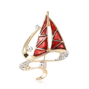 Exquisite sailboat brooch with red enamel and white crystals in a gold-plated finish