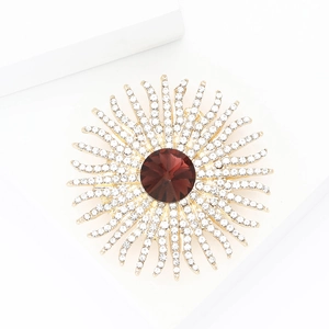 Elegant gold sunflower brooch with a central brown gemstone and sparkling white crystals
