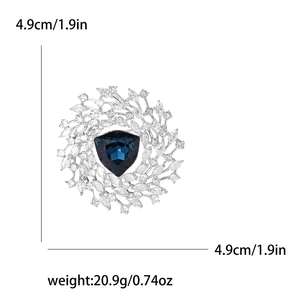 Detail view of round wreath brooch with blue center stone and clear crystals, 4.9cm size
