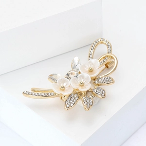 Eleganter Blumenstrauß-Brosche in Gold mit weißen Blütenblättern und funkelnden Strass