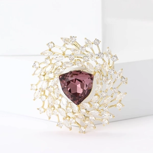 Elegant gold-plated brooch with a triangular purple zircon and sparkling white stones