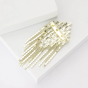 Macro detail of elegant rhinestone tassel brooch with gold-plated base and sparkling crystals