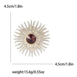 Elegant gold sunflower brooch with brown gemstone and white rhinestones on a white base