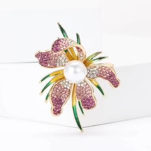 Elegant orchid flower brooch with purple crystals and central pearl on a gold base