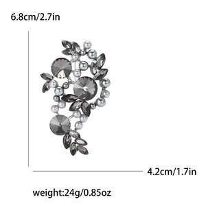 Detail view of vintage alloy brooch with pearls and crystals, size 6.8cm by 4.2cm