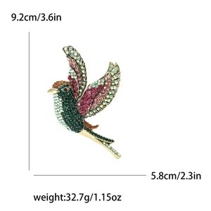 Élégante broche colibri avec strass colorés sur base dorée, hauteur 9,2 cm