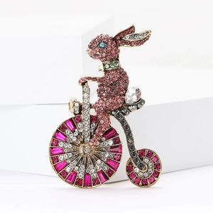 Broche lapin à monocycle en strass avec cristaux rouges et finition en métal doré