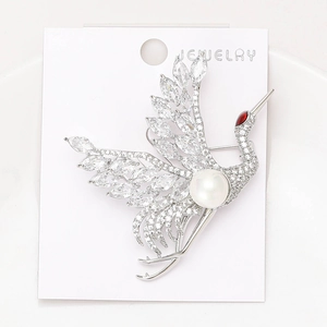 Detail of red-crowned crane brooch with cubic zirconia wings and central white pearl