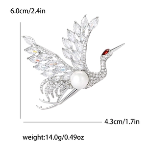 Elegant crane brooch with white crystals and faux pearl on a sleek silver finish