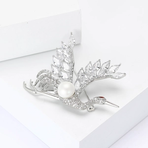 Elegant silver crane brooch with sparkling zircons and a white pearl on white cubes