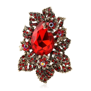 Broche vintage en alliage avec gemme rouge en forme de goutte et motifs floraux incrustés