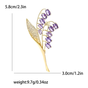 Elegante spilla a mughetto con pietre viola e finitura dorata lunga 5,8 cm