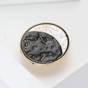 Creative celestial enamel brooch with star and moon design in gold and black finish