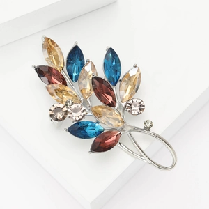 Détail de la broche feuille avec cristaux multicolores et zircons couleur champagne