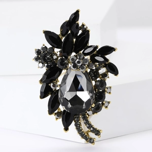Close-up of vintage bauhinia brooch with black rhinestones and gold-tone metal base