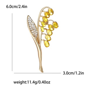 Spilla elegante a mughetto con cristalli gialli e strass per giacche e abiti
