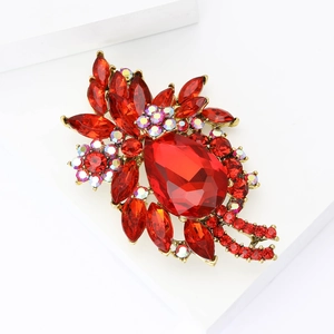 Elegant gold flower brooch with red pear-cut crystals and iridescent rhinestones