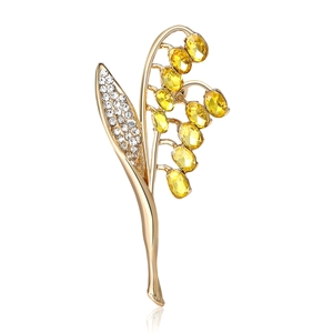 Spilla mughetto dorata con petali di cristallo giallo e strass bianchi brillanti