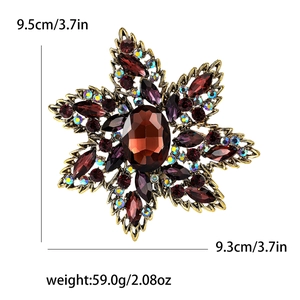Detailed view of bohemian star floral brooch with brown crystals and vintage gold finish