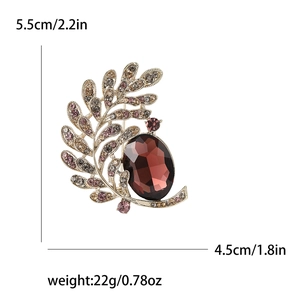 Vintage gold brooch with red oval gemstone and rhinestones, size 5.5cm by 4.5cm