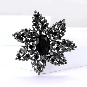 Close-up of gothic rhinestone flower brooch with black crystal on geometric stand