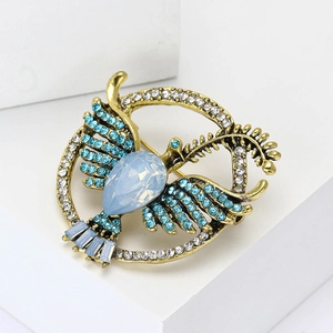 Vintage gold bird brooch with sky blue rhinestones and teardrop crystal centerpiece