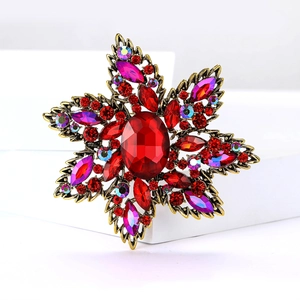 Vintage star-shaped rhinestone brooch with red oval gemstone and antique gold finish