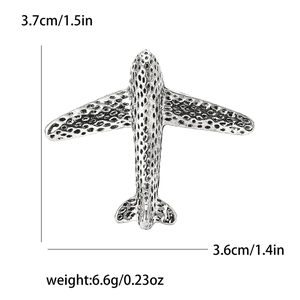Detailed view of silver aircraft brooch dimensions and textured alloy finish