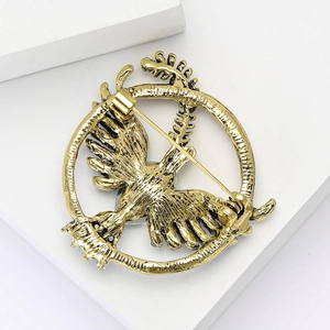 Detailed back view of vintage gold dove brooch with secure safety pin fastener