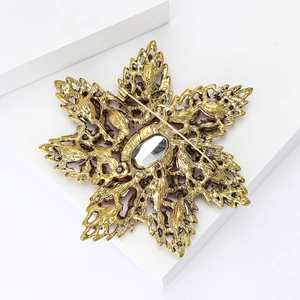 Detail view of the vintage gold floral brooch backside showing hollow craft and pin