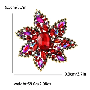 Vintage gold flower brooch with red crystals, measuring 9.5cm height and 9.3cm width