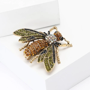 Luxury bee brooch in vintage gold alloy with colorful rhinestones on a white stand
