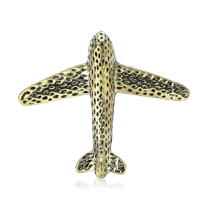 Vintage bronze airplane brooch with textured surface for suits and coats