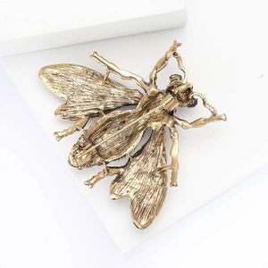 Macro detail of the honey bee brooch back with a secure rotating pin mechanism on alloy