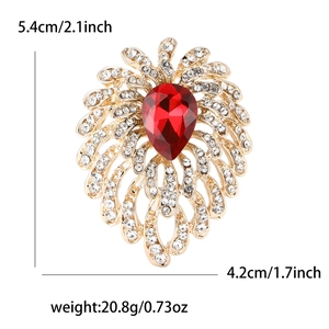 Detail view of rhinestone firework brooch with size metrics and red teardrop crystal