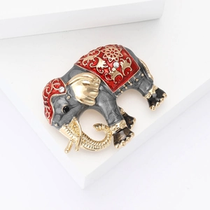 Vintage elephant brooch in dark grey enamel with red floral patterns and gold details