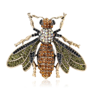Luxurious bee brooch with colorful rhinestones on a gold alloy base in macro view