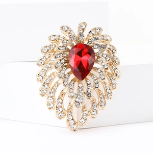 Macro shot of luxury red crystal brooch with sparkling rhinestones and golden base