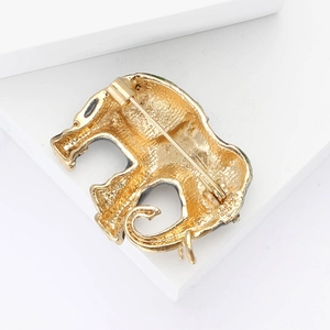 Close-up of the vintage elephant brooch back showing safety pin clasp and gold alloy texture