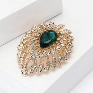 Elegant gold fireworks brooch with green waterdrop gemstone and white rhinestones